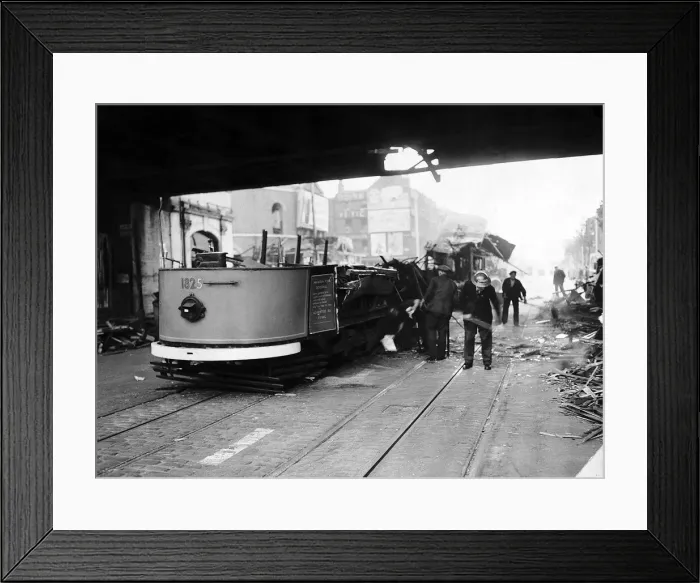 Framed Print : Remains of a tram car hit by the blast from a bomb during a WW2 air raid on London