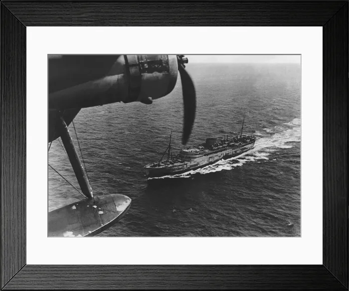 Framed Print : A Royal Air Force Coastal Command Sunderland flying boat flying over a transport ship Framed Print : A Royal Air Force Coastal Command Sunderland flying boat flying over a transport ship