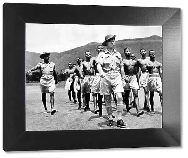 Sergeant George Thomas R. A. F. leading West African Air Corps recruits on a training march