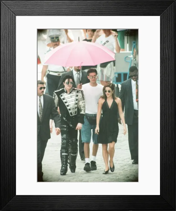 Framed Print : American pop singer Michael jackson with his new bride Lisa-Marie Presley walking