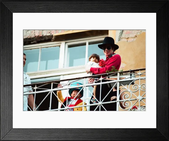 Framed Print : American pop singer Michael Jackson with young orphan Bela Farkas posing on a hotel