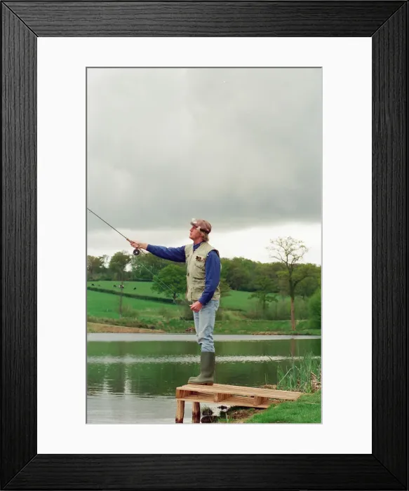 Framed Print : Radio Disc Jockey Chris Tarrant enjoying a spot of fishing in his spare time