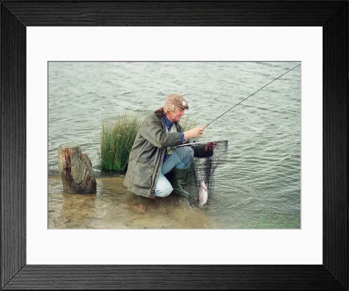 Framed Print : Radio Disc Jockey Chris Tarrant enjoying a spot of fishing in his spare time
