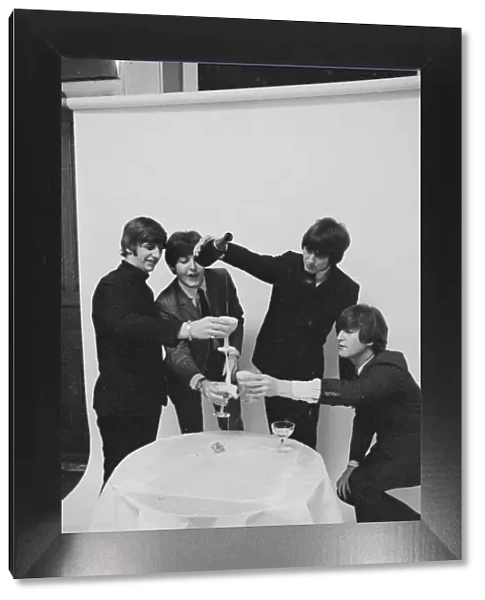 Beatles celebrating chart success. January 1965
