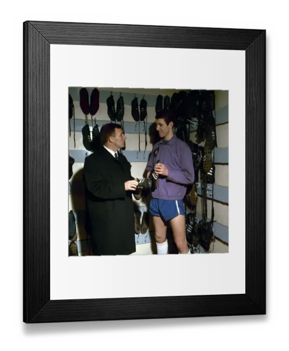 Framed Print : Chelsea footballer Peter Osgood in the boot room at Stamford Bridge with his manager Framed Print : Chelsea footballer Peter Osgood in the boot room at Stamford Bridge with his manager