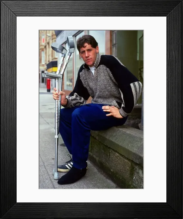 Framed Print : Ted McMinn sitting on wall with crutches September 1986 Framed Print : Ted McMinn sitting on wall with crutches September 1986