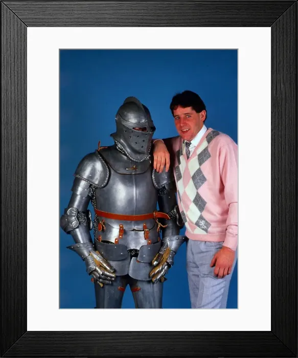 Framed Print : Ted McMinn leaning on suit of armour October 1986
