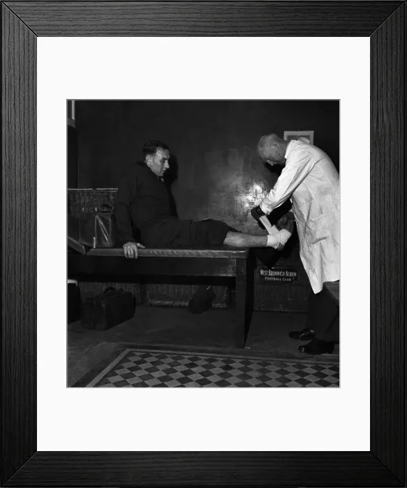 Framed Print : West Bromwich Albion F. C. Trainer Fred Read bandages ankle of footballer Billy Elliot