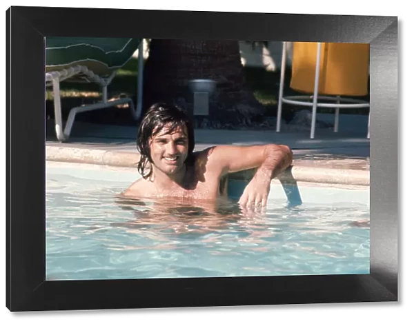 Footballer George Best relaxes in a swimming pool at his home in Palm Springs