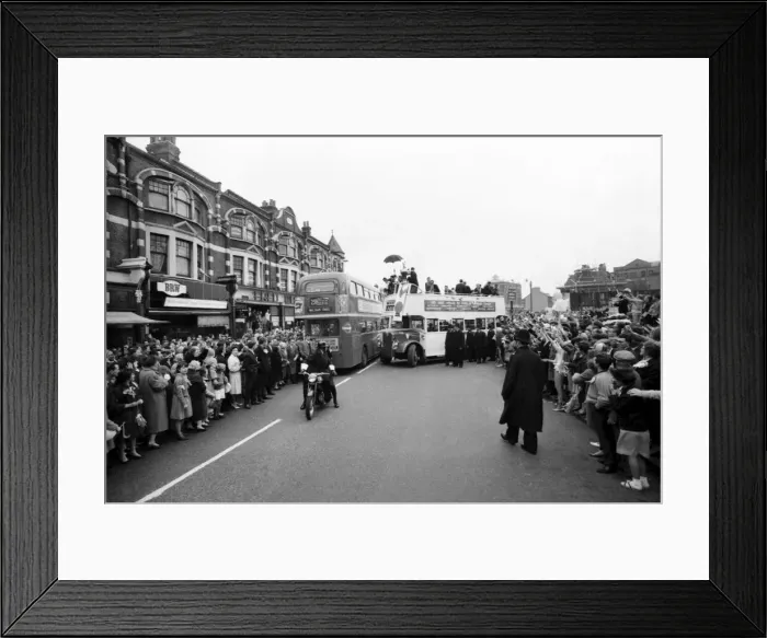 Framed Print : Tottenham Hotspur team hold the FA Cup trophy aloft from an open top double decker bus to