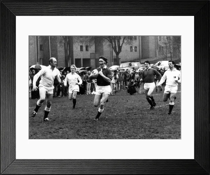 Framed Print : JPR Williams of the Old Wales team makes a break for the Old England Line during their Framed Print : JPR Williams of the Old Wales team makes a break for the Old England Line during their