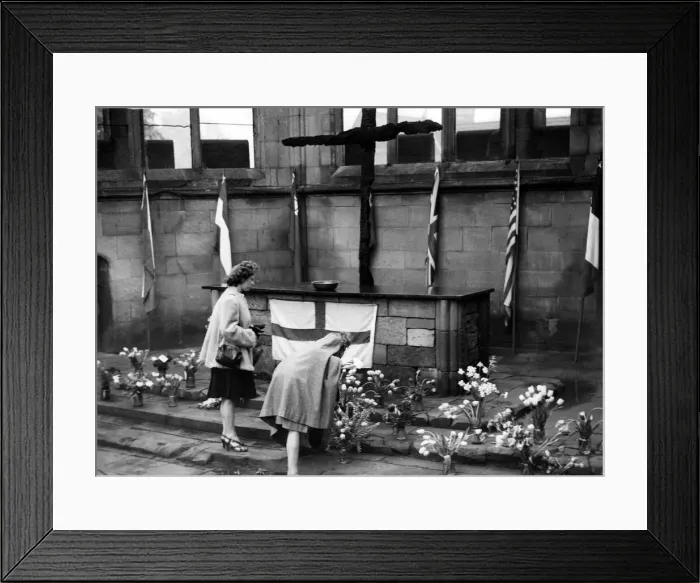 Framed Print : Two Coventry women place flowers in the sanctuary in the cathedral ruins in rememberance