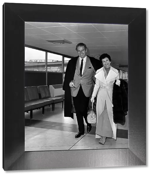 Charlton Heston, and his wife Lidia leaving London after attending the Premiere of his