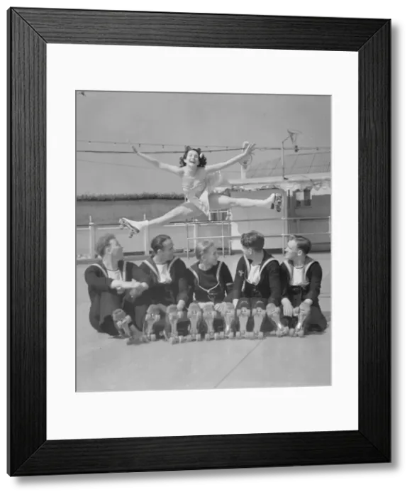 Framed Print : Sailors at the Southsea rink watch one of the performers perform an aerial splits 21st Framed Print : Sailors at the Southsea rink watch one of the performers perform an aerial splits 21st