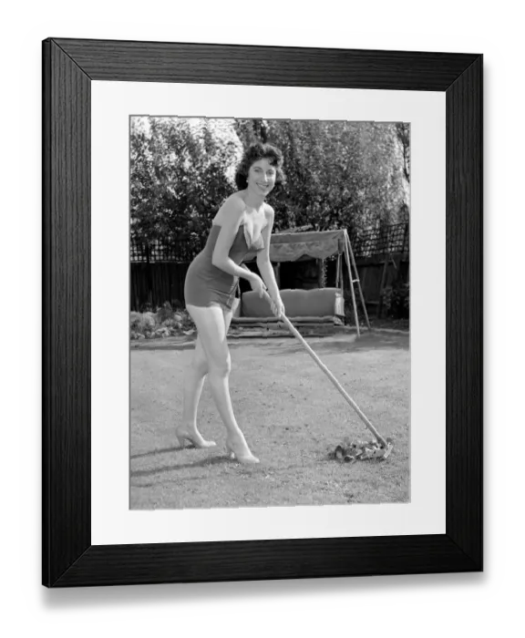 Framed Print : Woman wearing one piece swimsuit tenders to the lawn. Circa 1960 Framed Print : Woman wearing one piece swimsuit tenders to the lawn. Circa 1960
