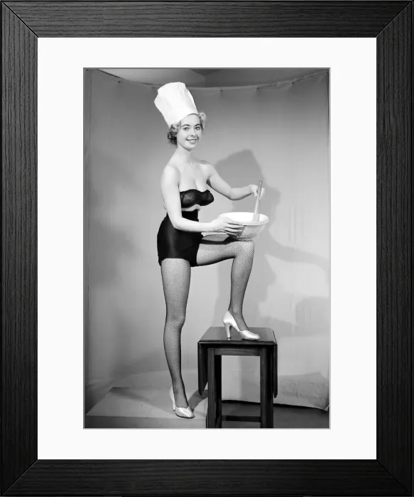 Framed Print : Woman modelling black lingerie and a chefs hat in a cooking photo shoot. Circa 1964 Framed Print : Woman modelling black lingerie and a chefs hat in a cooking photo shoot. Circa 1964