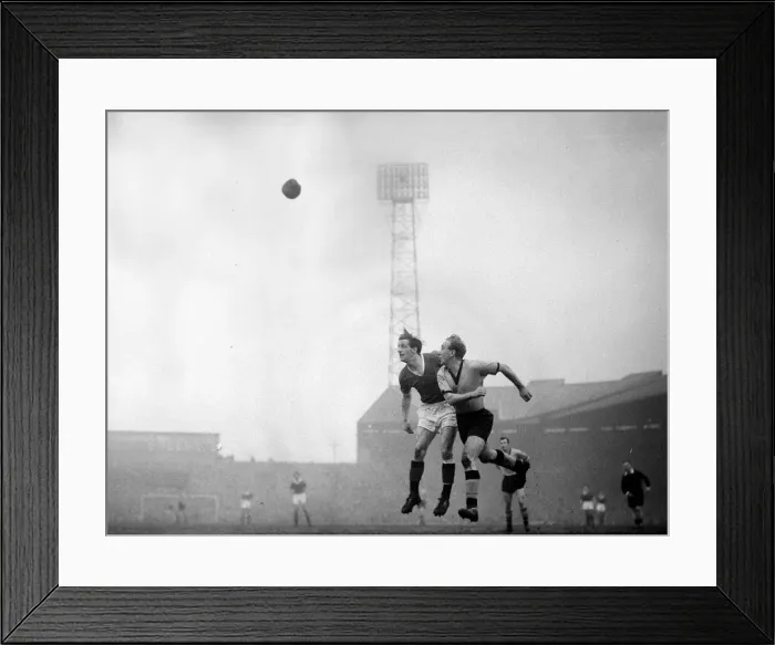 Framed Print : Manchester United v Wolverhampton Wanderers -Billy Wright beats Viollet in the air during