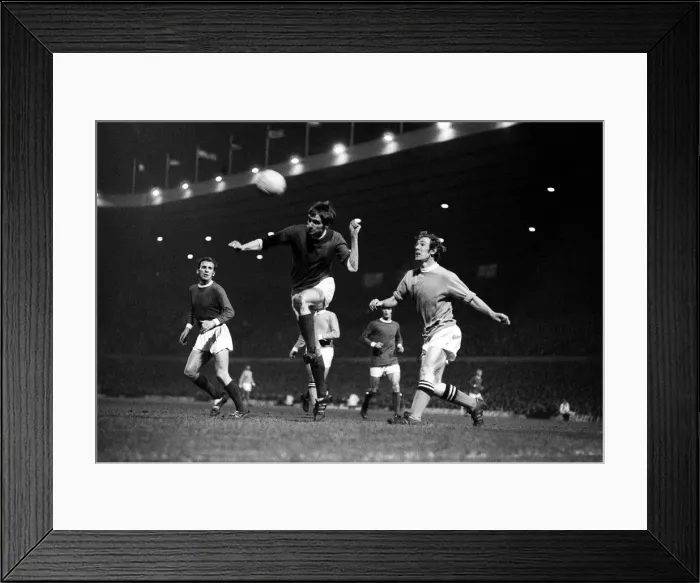 Framed Print : George Best heads the ball clear December 1969 watched by Pat Crerand