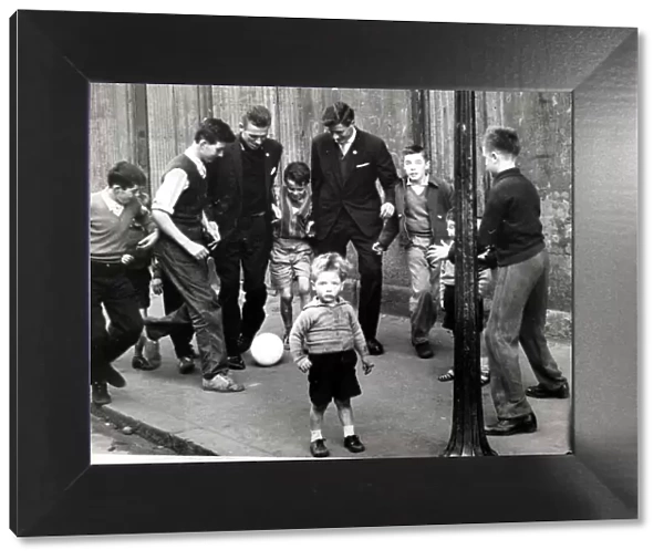 Pat Crerand with kids in the street 1960 pat Crerand on left football children