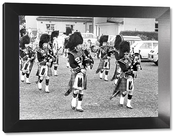 The pipes and drums of the Newcastle City Pipe Band opening a summer fayre in July 1981