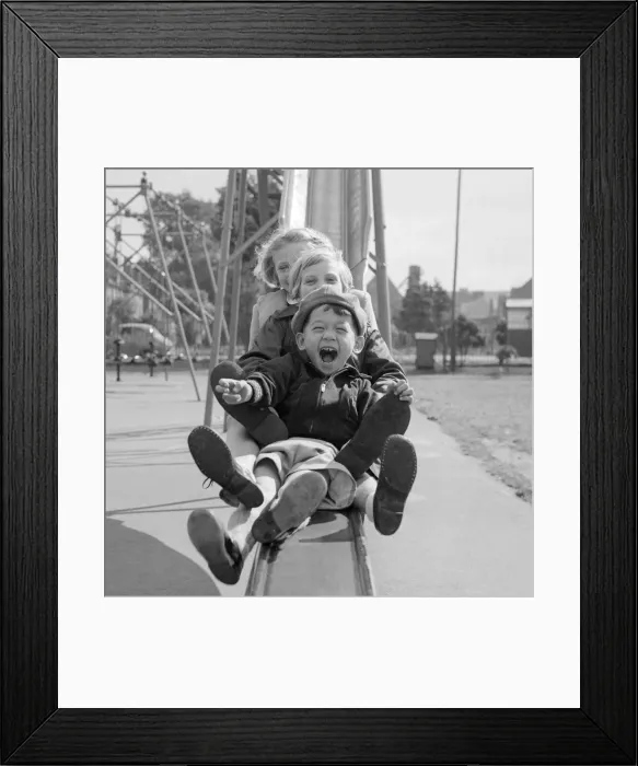 Framed Print : Children playing smiling going down a slide chute September 1955 at Beeston Notts Framed Print : Children playing smiling going down a slide chute September 1955 at Beeston Notts