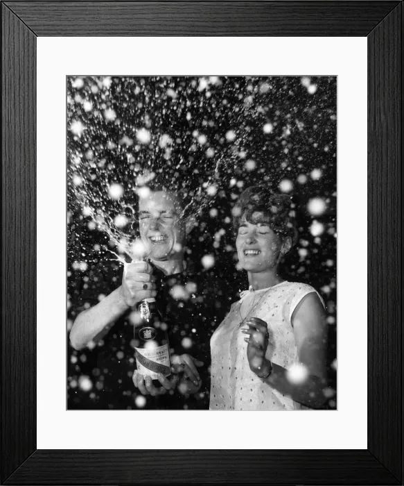 Framed Print : Couple celebrate the new year with a bottle of champagne 1st January 1965