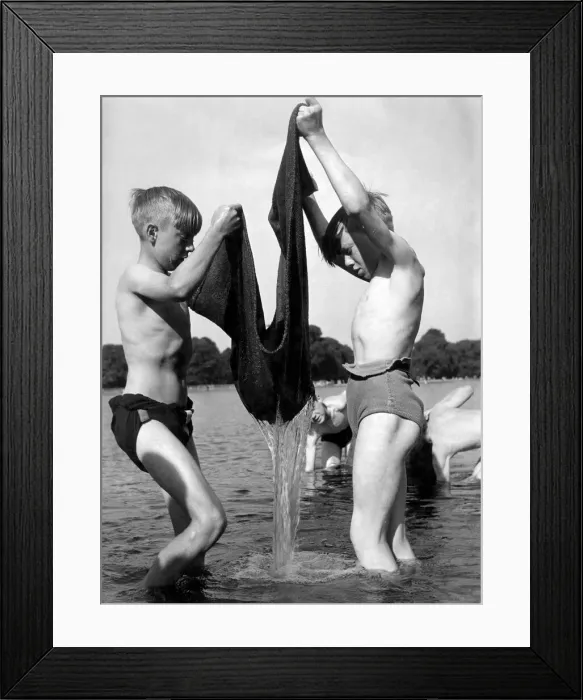 Framed Print : Children fishing with the aid of a sack 5th June 1952. The youngsters drag