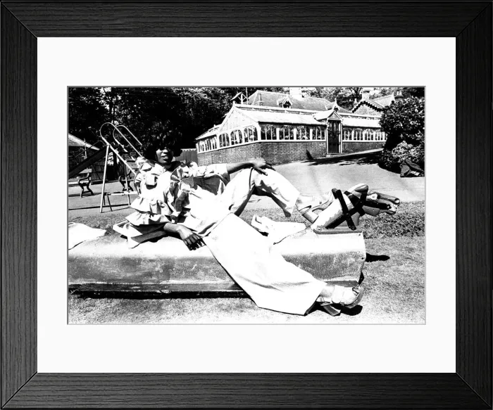 Framed Print : A fashion shoot from 30 May 1972 - A model wears flared trousers and platform shoes Framed Print : A fashion shoot from 30 May 1972 - A model wears flared trousers and platform shoes