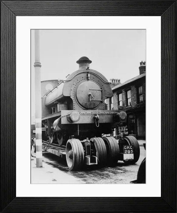 Framed Print : A locomotive train is drawn through the streets of Stretford on the way to the repair