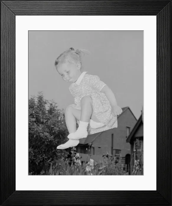 Framed Print : Deborah Blake seen here bouncing gaily on a trampoline in the garden of her family home Framed Print : Deborah Blake seen here bouncing gaily on a trampoline in the garden of her family home