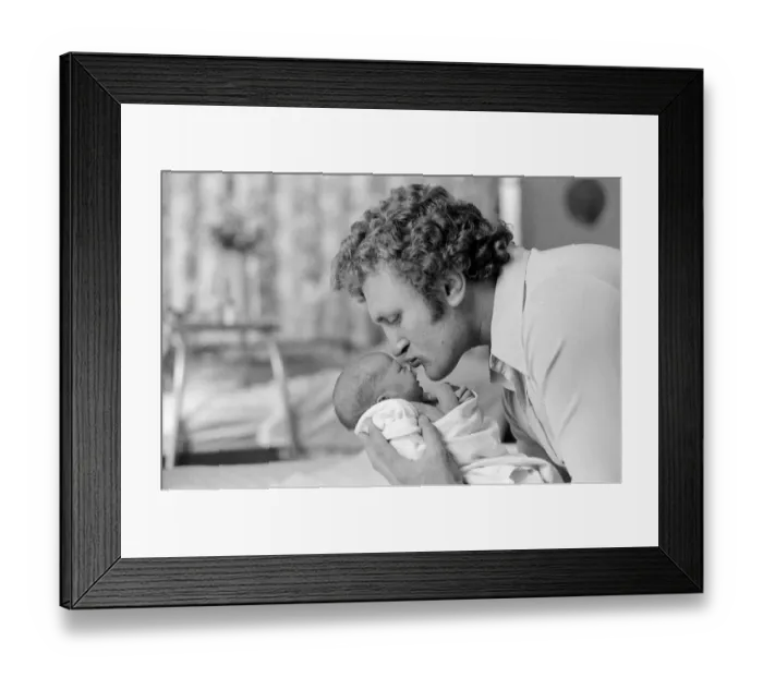 Framed Print : Former British European Heavyweight champion boxer Joe Bugner kisses his new born baby