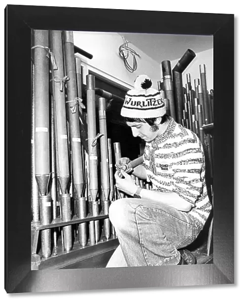 Robin Roper sets up the clarinet pipes on the Wurlitzer organ which had been left to rot