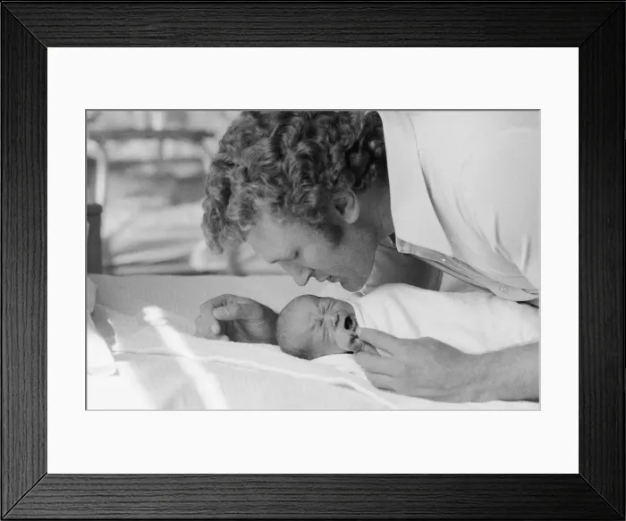 Framed Print : Former British European Heavyweight champion boxer Joe Bugner kisses his new born baby Framed Print : Former British European Heavyweight champion boxer Joe Bugner kisses his new born baby