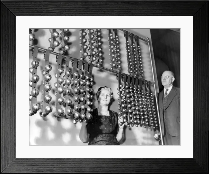 Framed Print : Mrs. Ritchie operates the 424 sleigh bells while her husband looks on in april 1960
