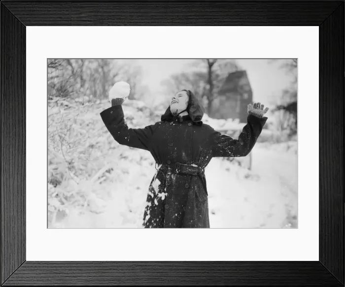 Framed Print : A young girl of St. Lythams near Cardiff, Wales, takes part in a snowball fight with Framed Print : A young girl of St. Lythams near Cardiff, Wales, takes part in a snowball fight with
