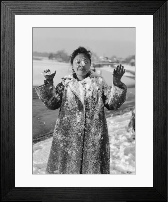 Framed Print : Philippine dancers have a snowball fight in London. One of the woman throwing