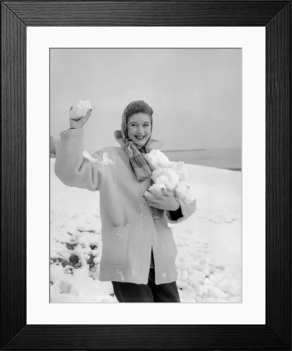 Framed Print : A woman having a snowball fight with her friend on Hastings beach. 8th March 1955 Framed Print : A woman having a snowball fight with her friend on Hastings beach. 8th March 1955