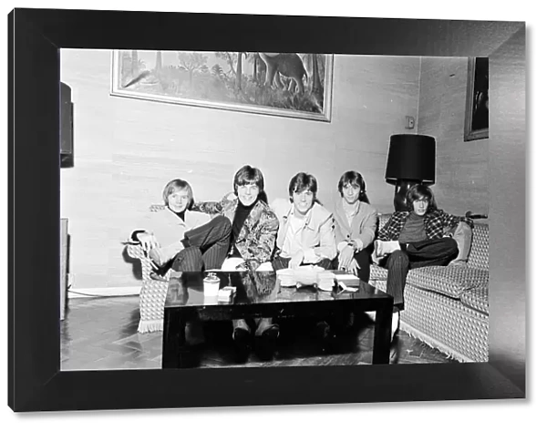 The Bee Gees seen here watching television in their hotel room 17th October 1967