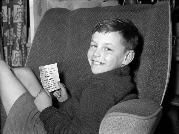 A young Fulham fan holds his ticket for the FA Cup 6th round match against Bristol Rovers