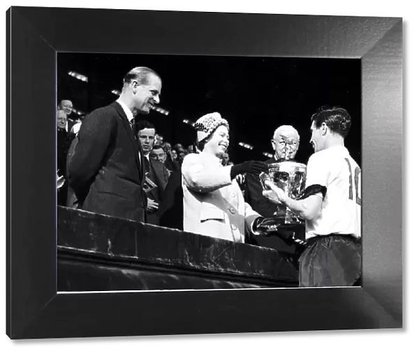 HRH Queen Elizabeth II presents the international championship trophy to Johnny Haynes