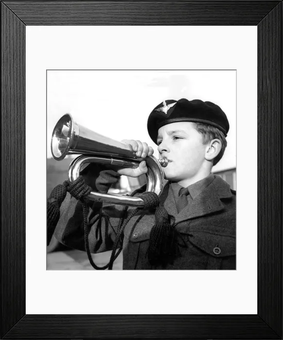 Framed Print : Philip Hall getting a tune from his copper bugle in December 1962