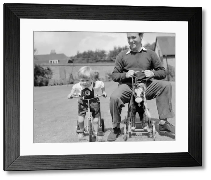 Framed Print : Actor Richard Todd playing with his son Peter at home. 5th November 1954 Framed Print : Actor Richard Todd playing with his son Peter at home. 5th November 1954