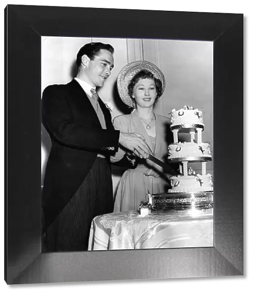 Actor Richard Todd with his bride Catherine Bogle cutting the cake on their wedding day