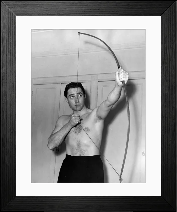 Framed Print : Actor Richard Todd poses with a bow at his home after being chosen to play the part of Framed Print : Actor Richard Todd poses with a bow at his home after being chosen to play the part of