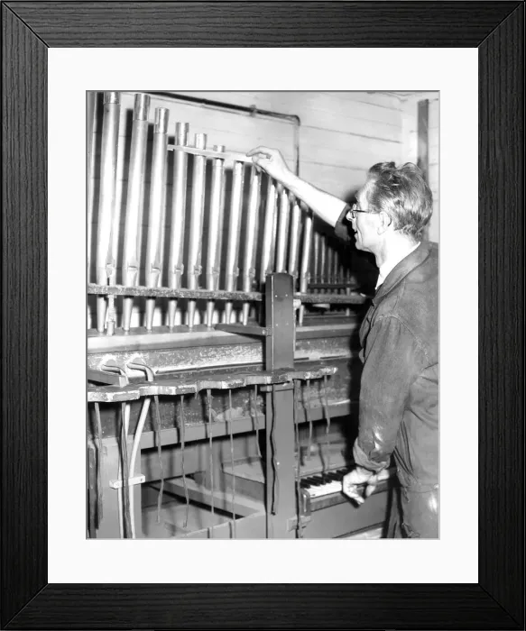 Framed Print : Mr. Leslie Rowland, aged 53, tunes the pipes of this organ on a voicing machine in Framed Print : Mr. Leslie Rowland, aged 53, tunes the pipes of this organ on a voicing machine in