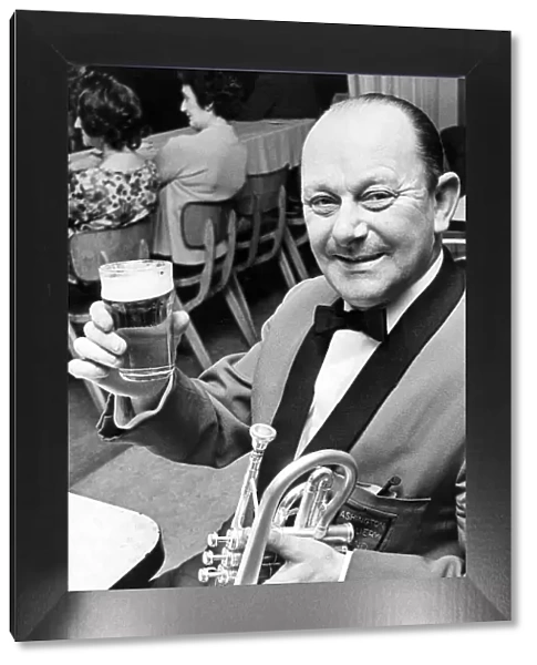 Bob Dunning a member of the Ashington Colliery Band raises his glass in a toast to his