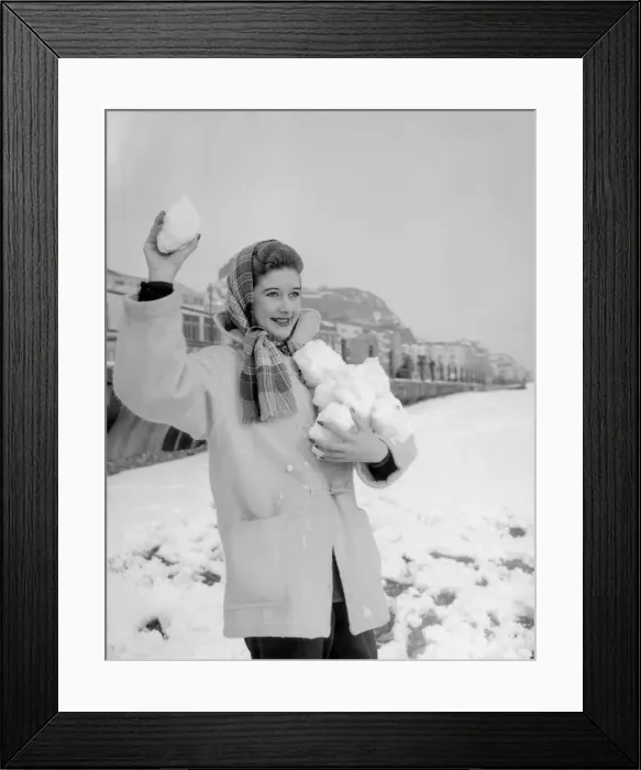 Framed Print : A woman having a snowball fight with her friend on Hastings beach. 8th March 1955 Framed Print : A woman having a snowball fight with her friend on Hastings beach. 8th March 1955