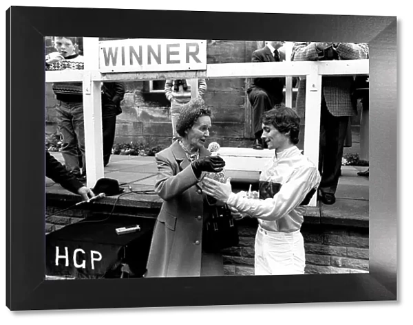 Jockey Walter Swinburn receives a winners trophy at Gosforth Park Racecourse, Newcastle