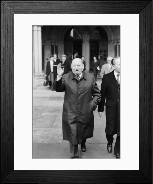 Framed Print : Media Mogul Lew Grade poses outside the High Court in London, smoking one of his cigars