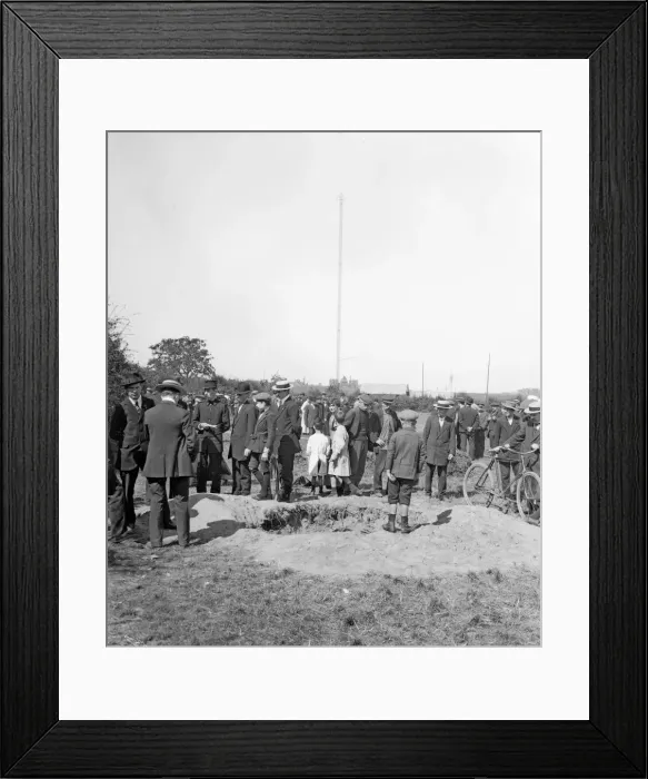 Framed Print : Residents of Antwerp inspect one of the craters made as a result of one of the three air